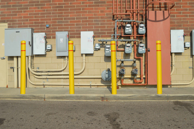 Line of Flat Top Bollard Covers in yellow with red reflective tape