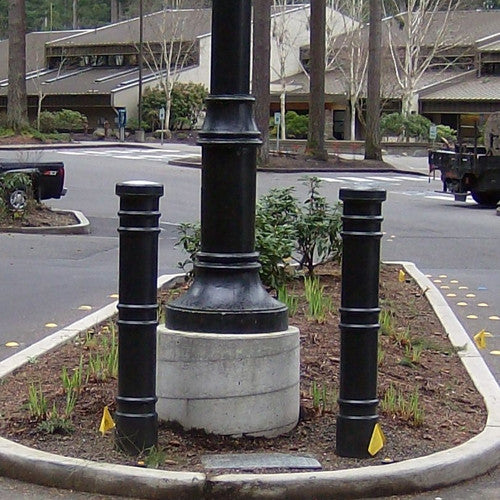 Bollards and Sleeve's Metro Decorative Bollard Covers in Parking Lot Island