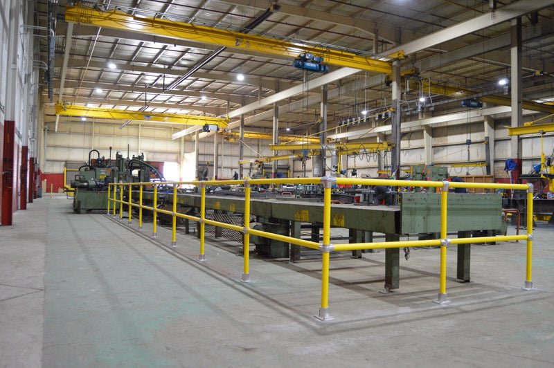 Steel Pipe & Plastic Handrail lining an angle master on a shop floor 