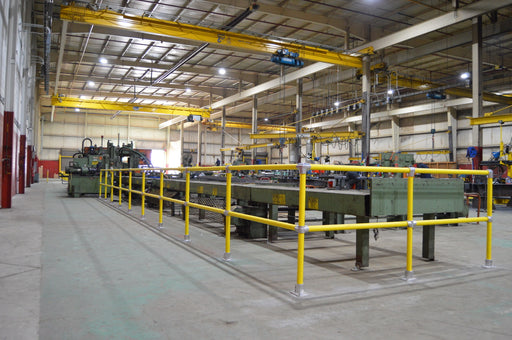 Steel Pipe & Plastic Handrail lining an angle master on a shop floor 