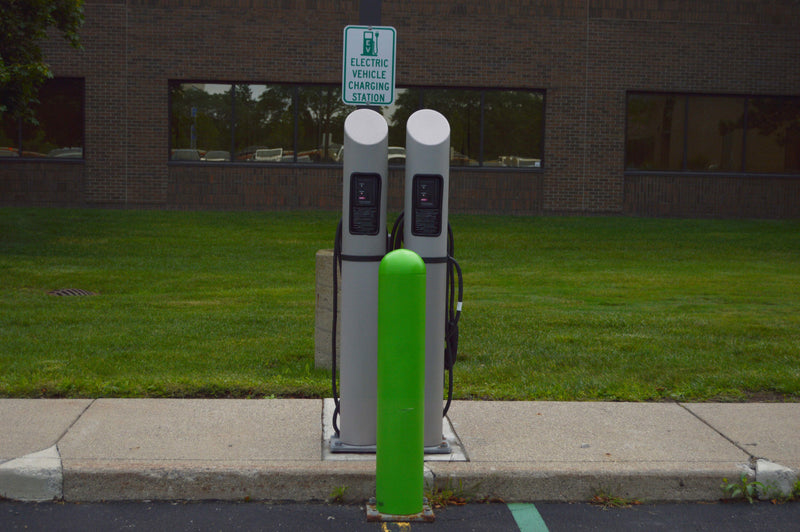 Double Electric Vehicle Charging Stations with protective bollard in front 