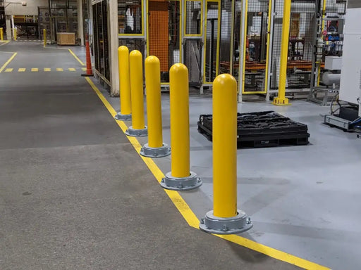 Yellow safety barriers in a warehouse setting