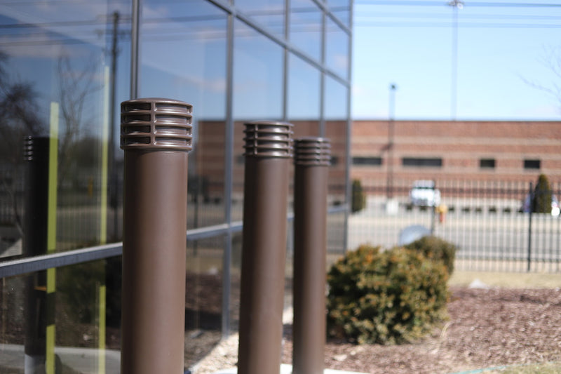 6" Cinco Decorative Bollard Covers lining a storefront 