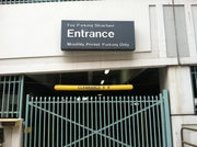 Entrance sign for a parking structure with a fence in front